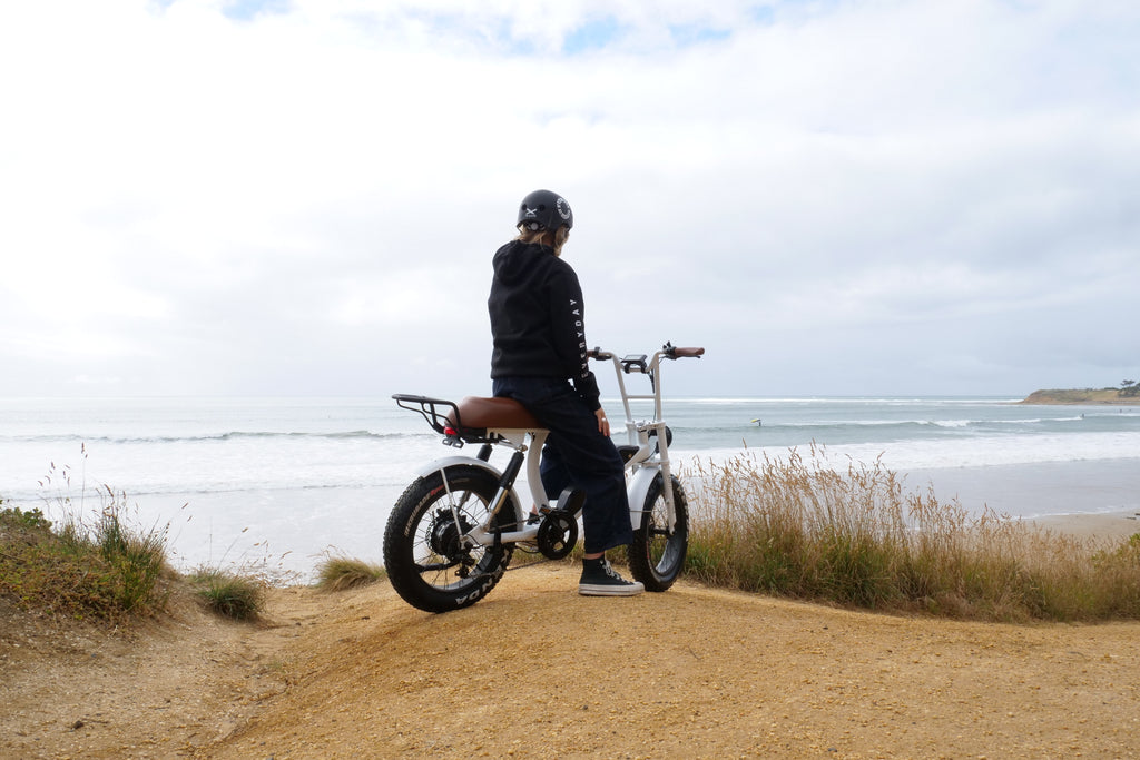 The Pezz matte white bike with model wearing and everyday australia hoodie