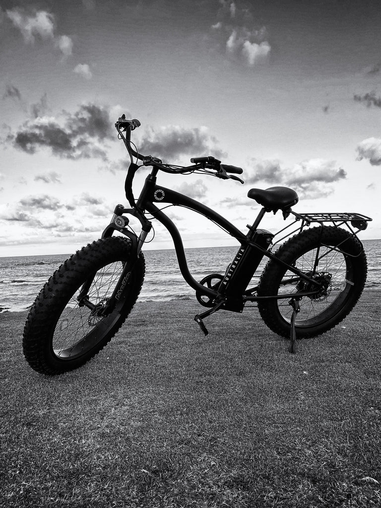Black and white picture of bike at beach